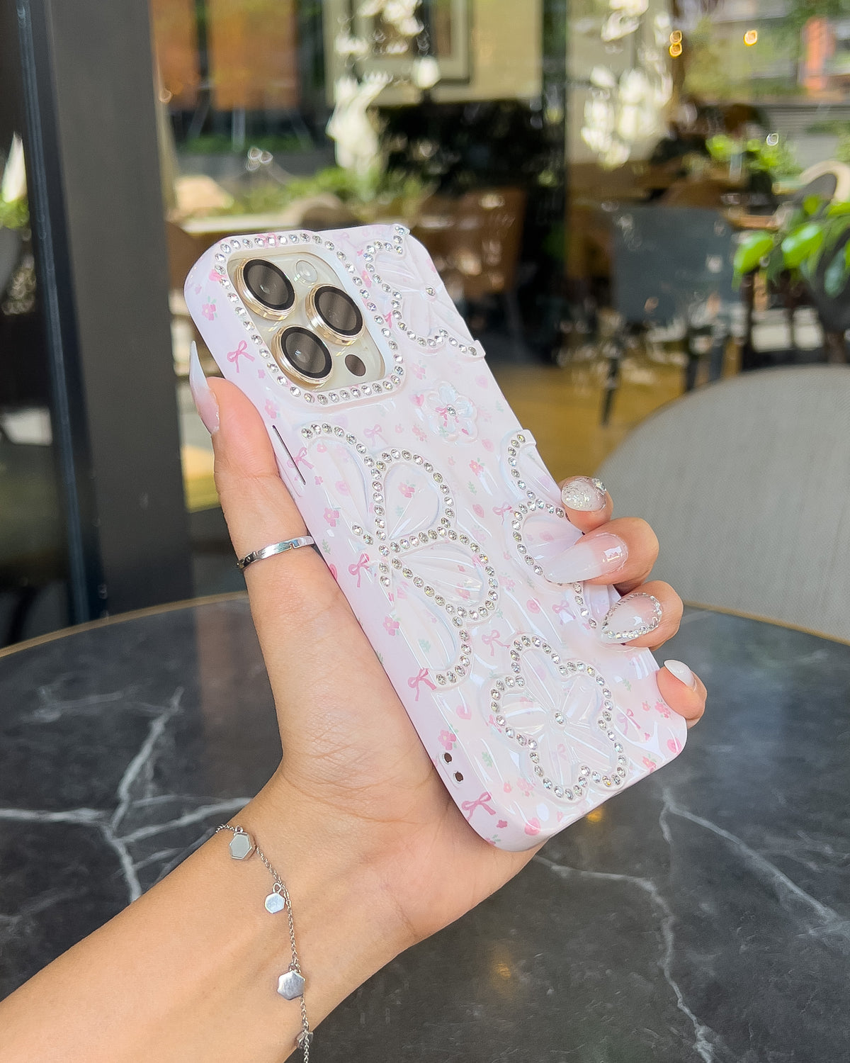 Blossom Crush pink pearlescent iPhone case with rhinestone flowers and pink bows โ TOKFO
