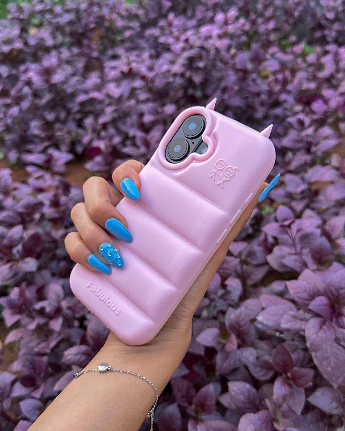 Light pink TOKFO Puffer Devil Horn phone case held at an angle showing the puffer pattern