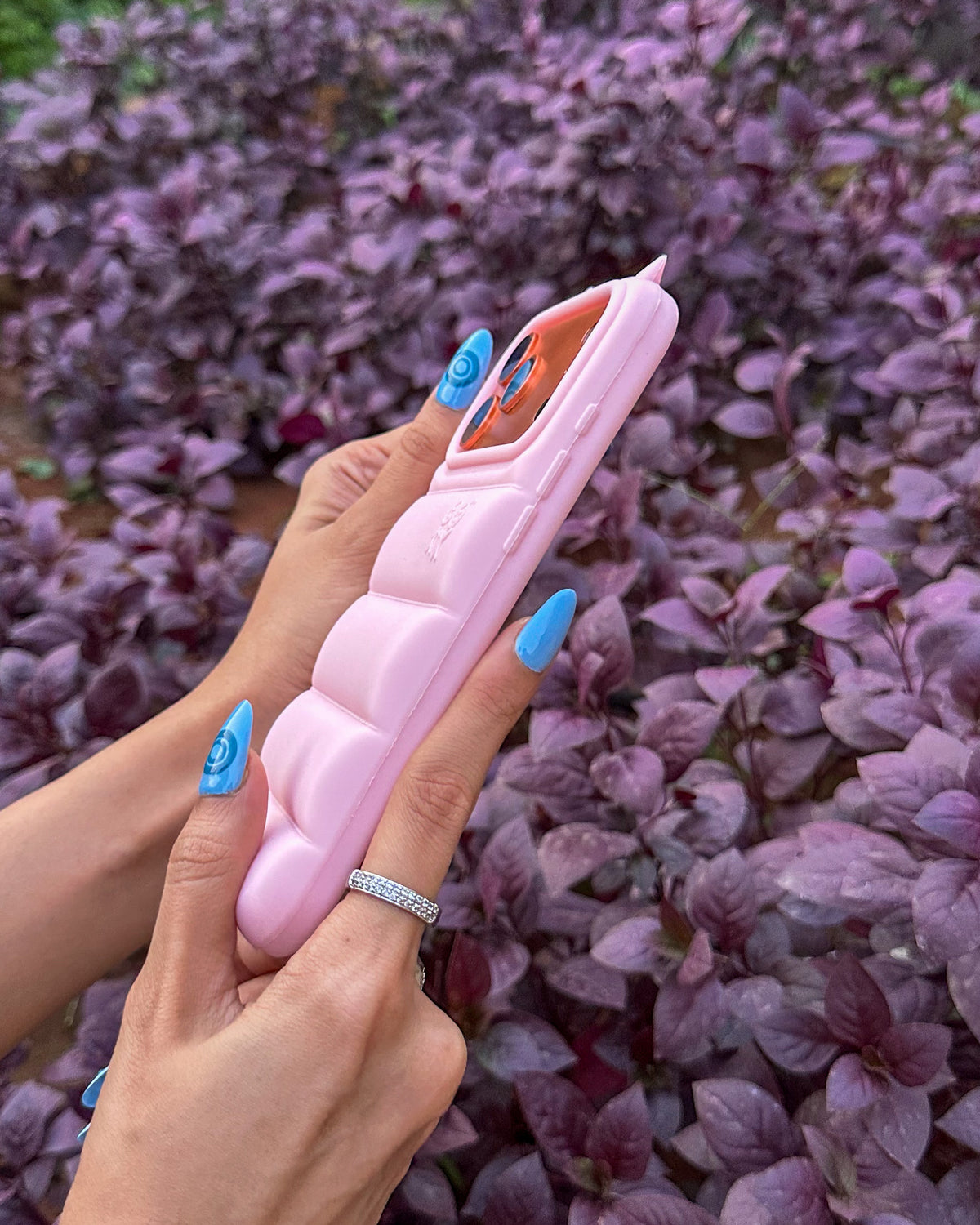 Side view of the light pink TOKFO Puffer Devil Horn phone case showing the puffy silicone edge