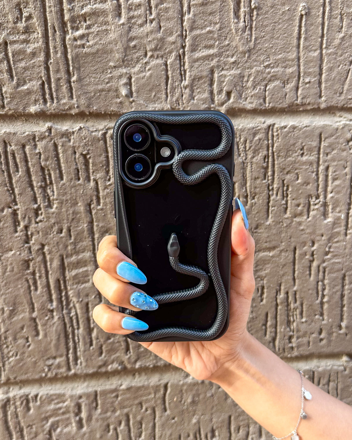 TOKFO Snake open-back iPhone bumper phone case with bold 3D black snake design, held in hand