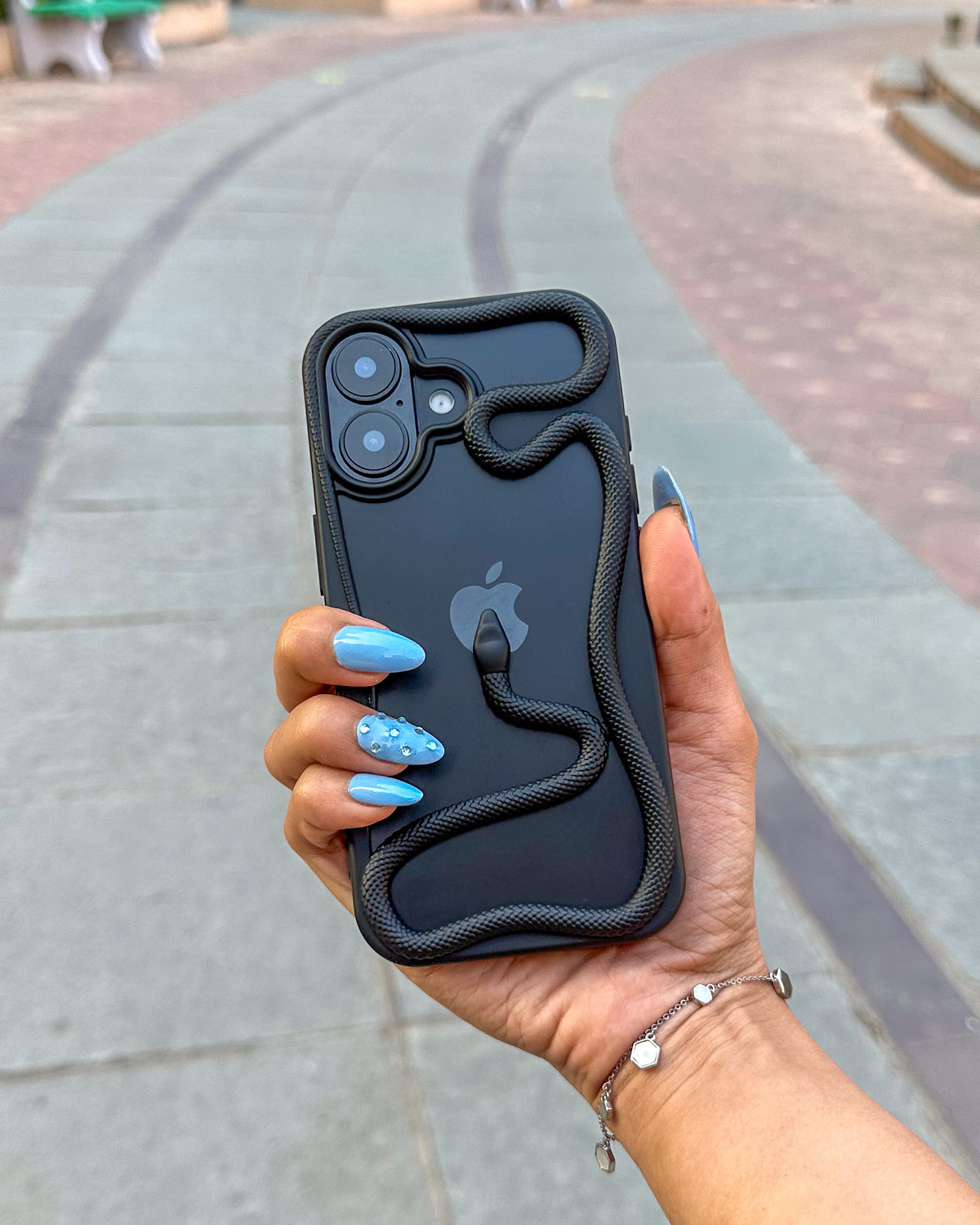 Black TOKFO Snake open-back phone case held in hand outdoors