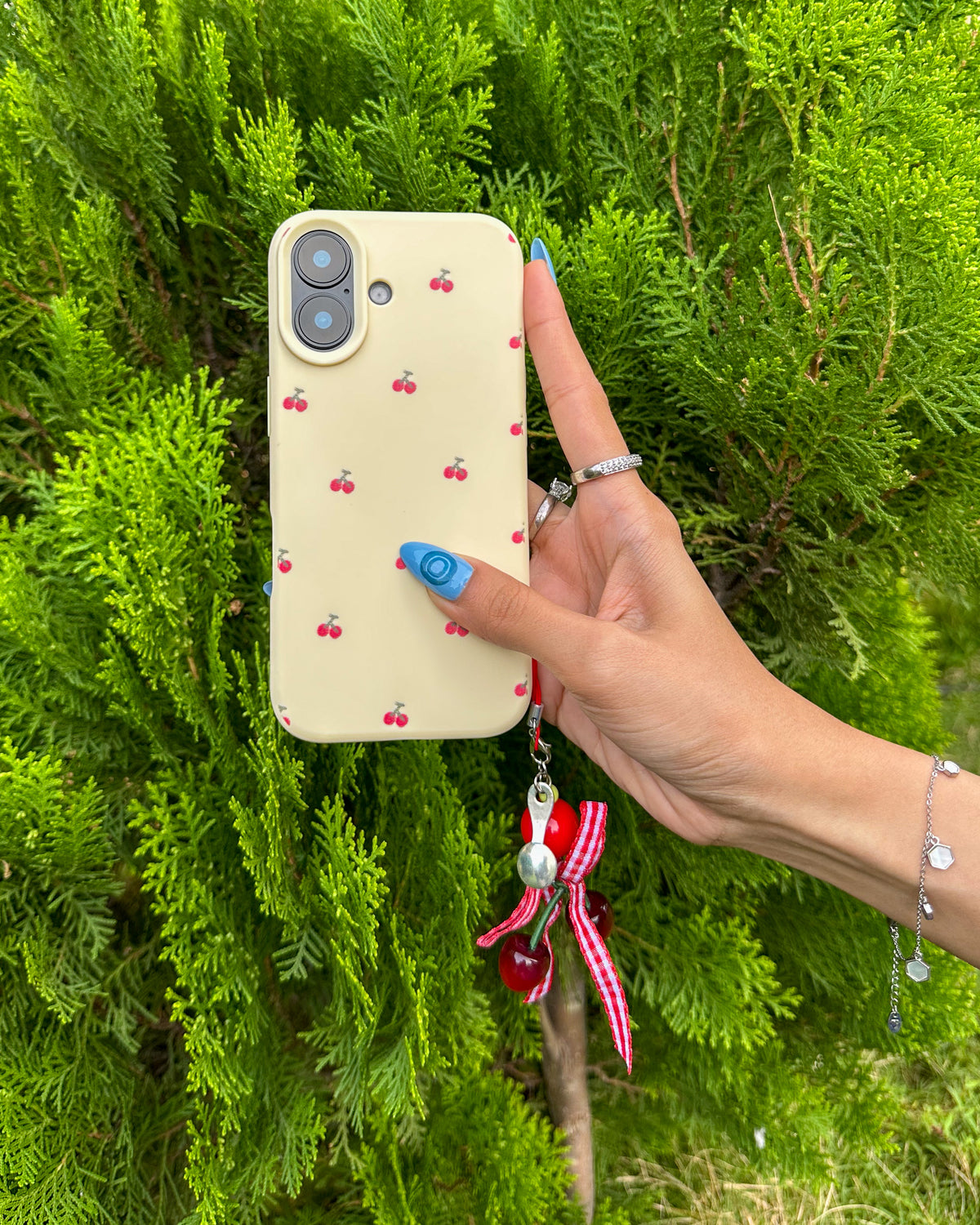 Back of the TOKFO Cherry phone case with cherry print and hanging cherry charm