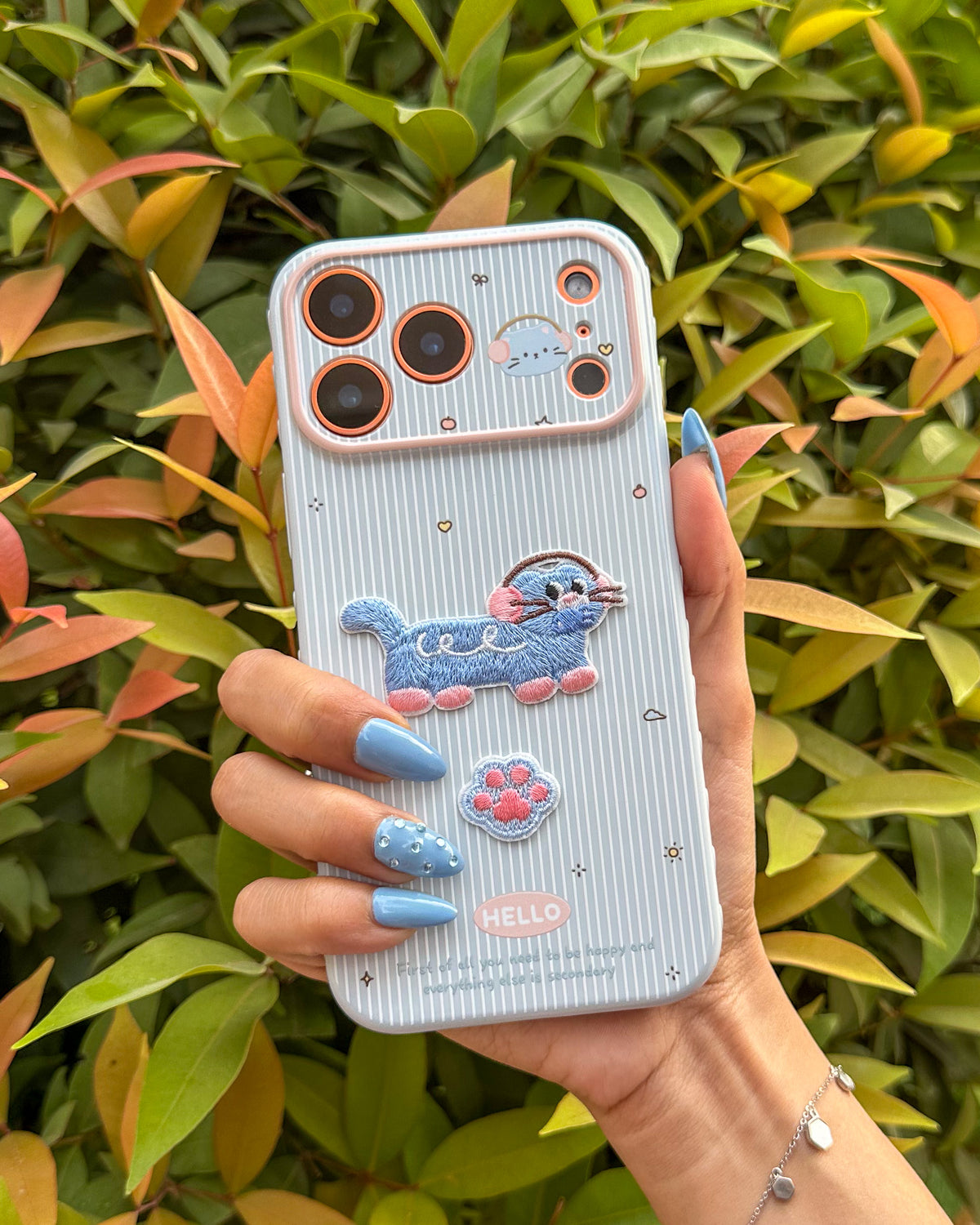 TOKFO Hello Cat iPhone phone case with 3D embroidered cat patch and paw detail, held in hand