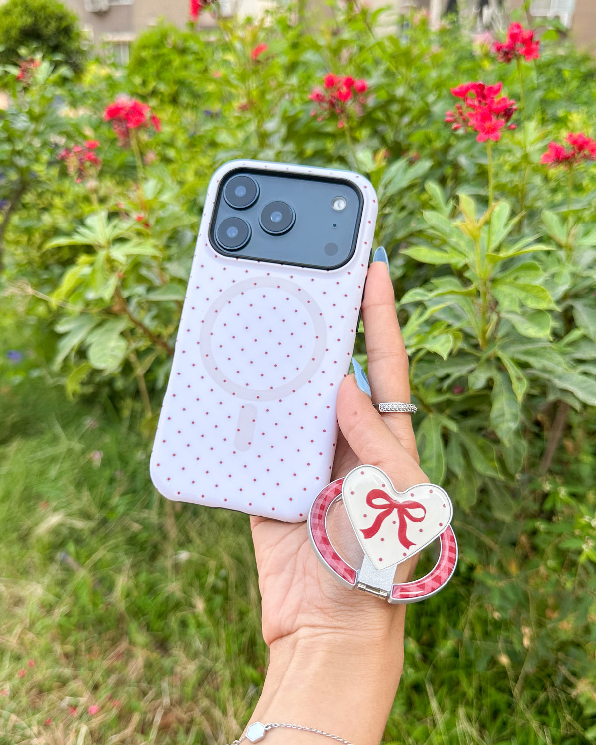 Magnetic heart-shaped kickstand held next to the TOKFO Polka Dot Bow Stand MagSafe compatible phone case