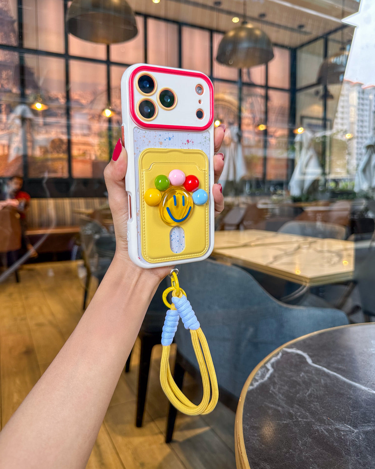 TOKFO Smiley phone case with paint-splatter print back and wrist strap