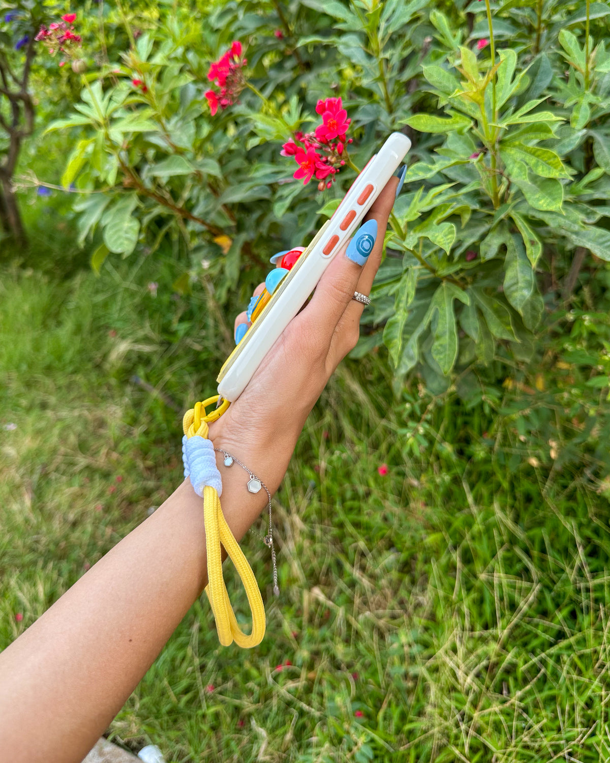 Side view of the TOKFO Smiley iPhone phone case with the wrist strap attached
