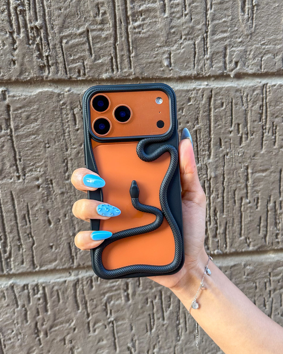 Black TOKFO Snake bumper phone case on an iPhone, showing the 3D snake wrapped around the frame