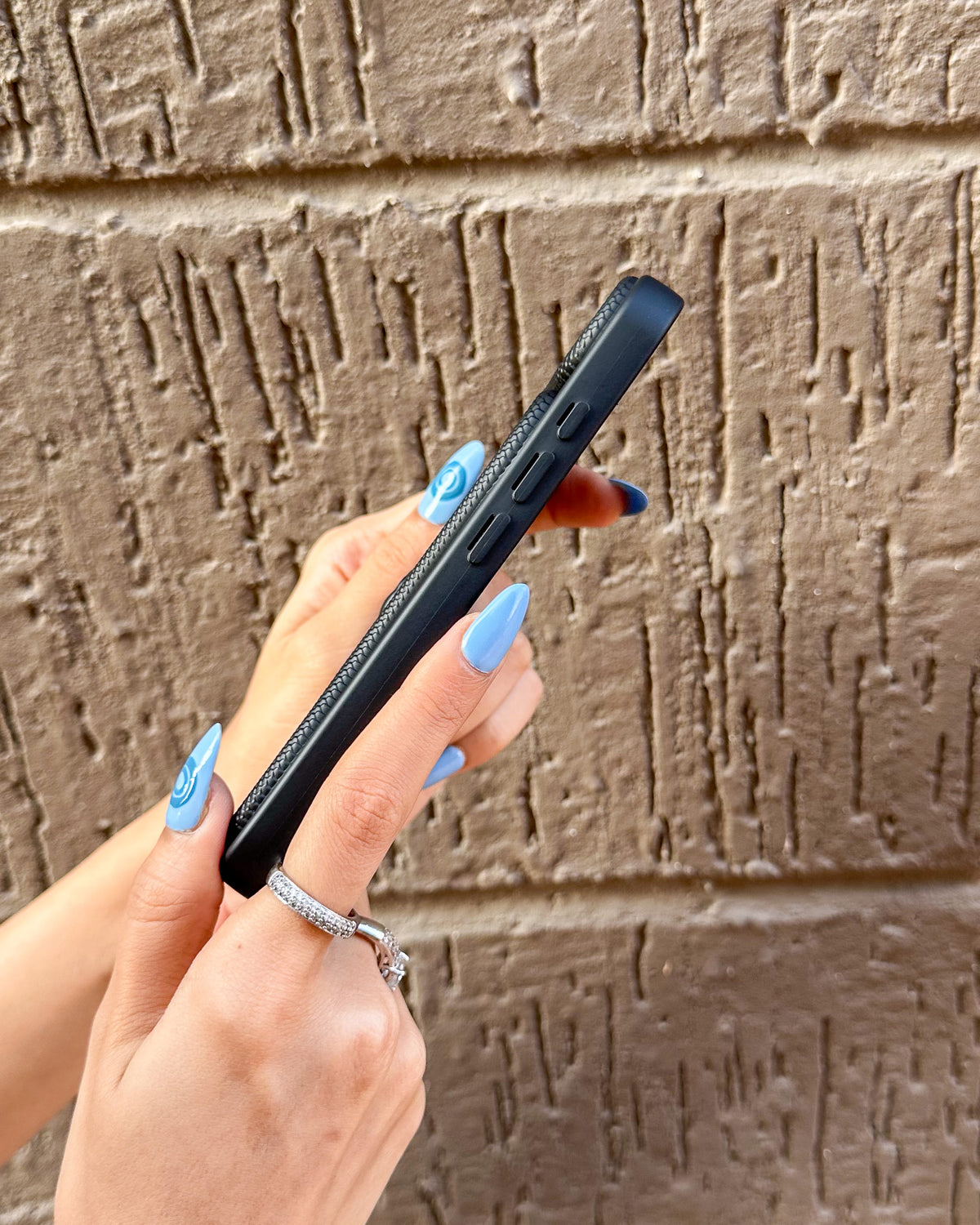 Side view of the black TOKFO Snake iPhone phone case showing the responsive buttons