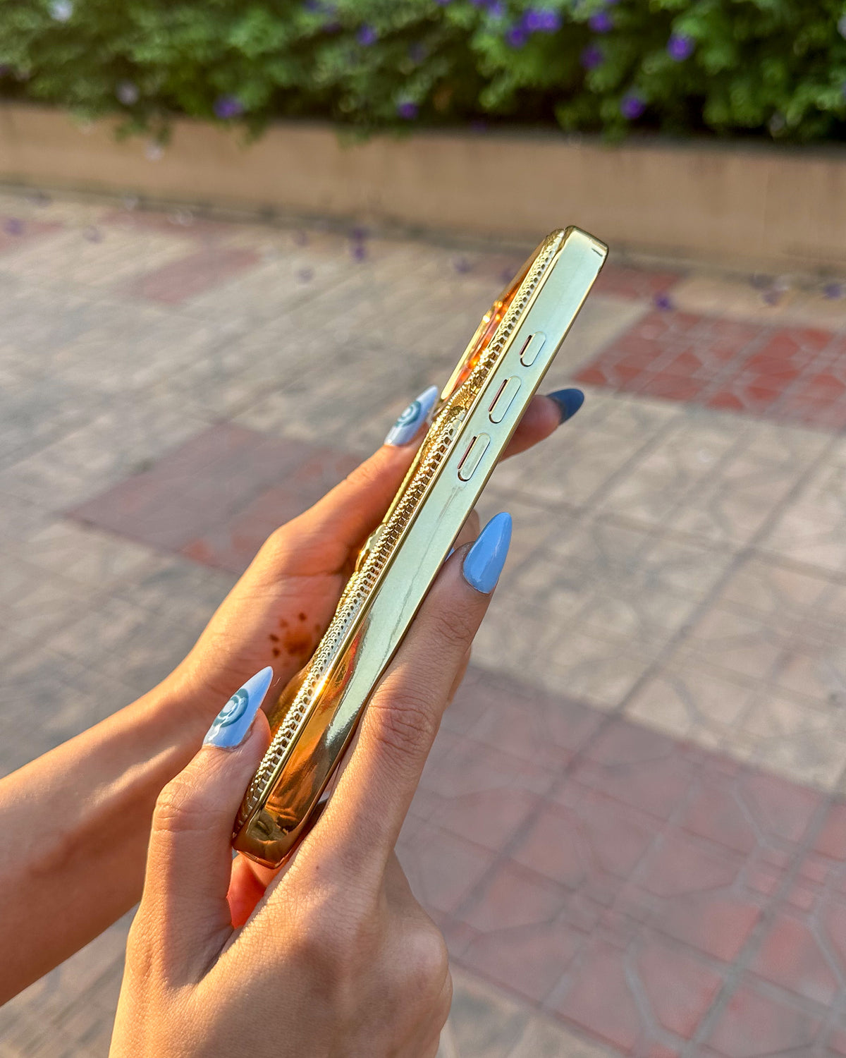 Side view of the golden TOKFO Snake iPhone phone case showing the responsive buttons